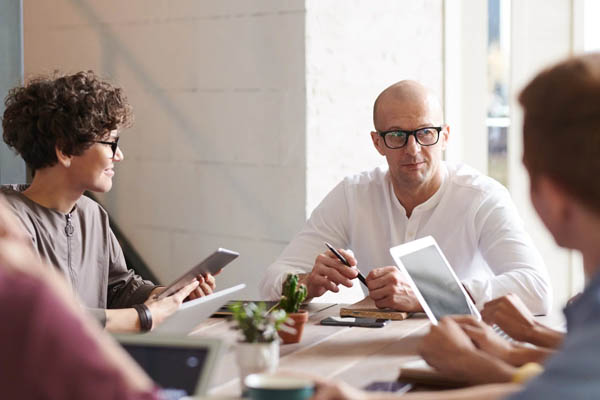 people seated looking at invoices