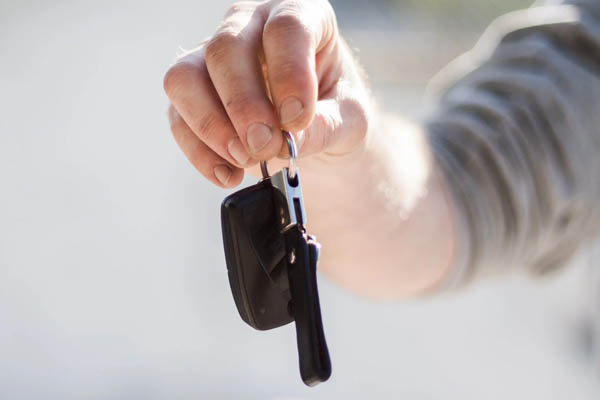 person handing car keys