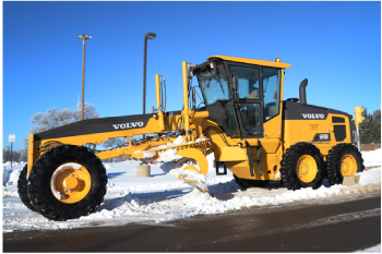 Volvo grader maintaining snow